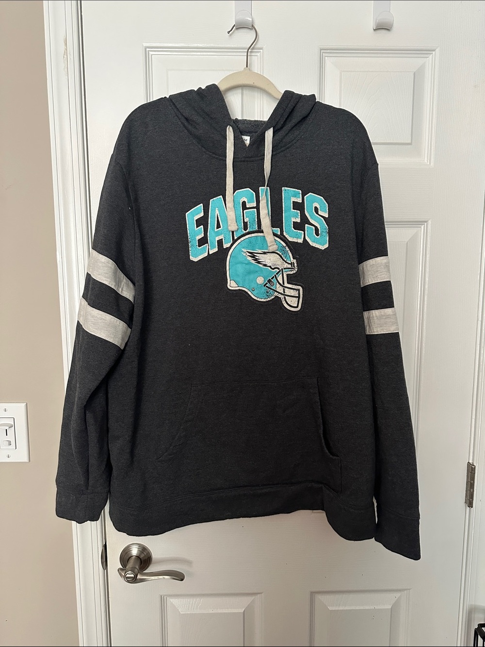 Eagles Black Pullover Hoodie with Teal Helmet Graphic